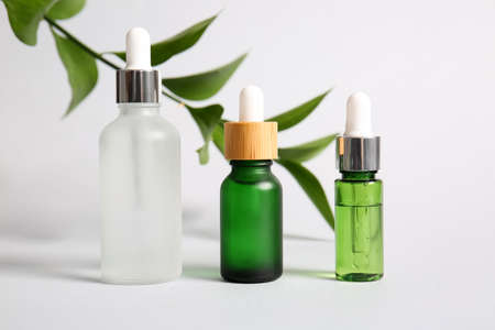 Bottles of natural serum on white background