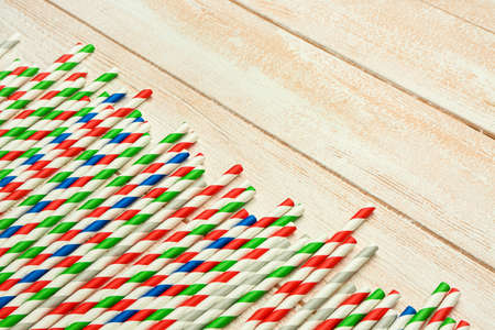 Stylish straws for drinks on light wooden backgroundの写真素材