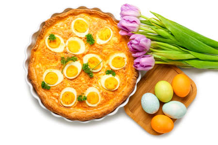 Tasty Easter tart, painted eggs and tulip flowers on white background