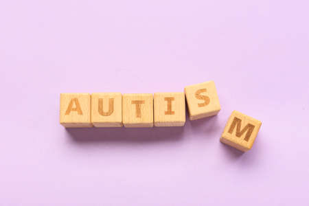 Wooden cubes with word AUTISM on lilac backgroundの写真素材