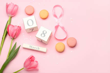 Calendar with date of International Women's Day celebration, macaroons and tulip flowers on pink backgroundの写真素材