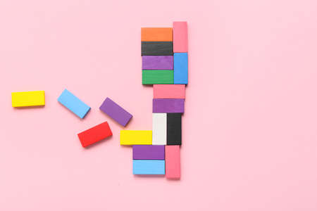 Colorful blocks on pink background. Concept of autistic disorder