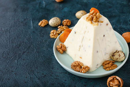 Tasty curd Easter cake with walnuts on dark color background