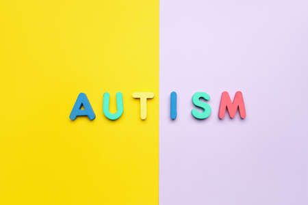Word AUTISM on yellow and lilac backgroundの写真素材