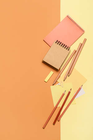 Notebooks with pencils on color backgroundの写真素材