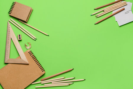 Frame made of stationery supplies on green backgroundの写真素材