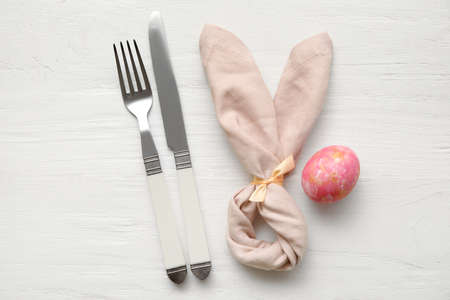Stylish table setting for Easter celebration on white wooden background