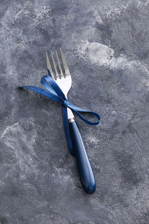 Fork with ribbon on grunge backgroundの写真素材