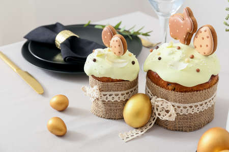 Easter cakes with eggs on light tablecloth, closeup