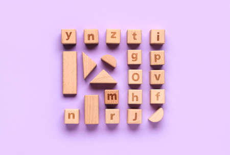 Wooden cubes with letters and blocks on lilac backgroundの写真素材