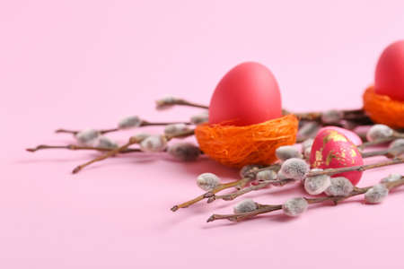 Painted Easter eggs and pussy willow branches on pink backgroundの写真素材