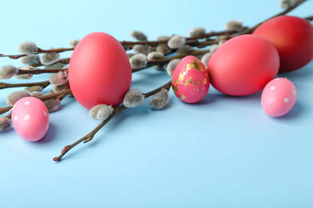 Painted Easter eggs and pussy willow branches on blue backgroundの写真素材