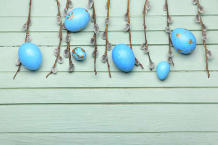 Painted Easter eggs and pussy willow branches on wooden backgroundの写真素材
