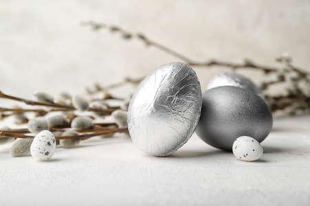 Easter eggs and pussy willow branches on light tableの写真素材