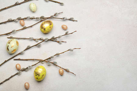 Painted Easter eggs and pussy willow branches on light background