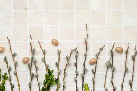 Painted Easter eggs and pussy willow branches on light background