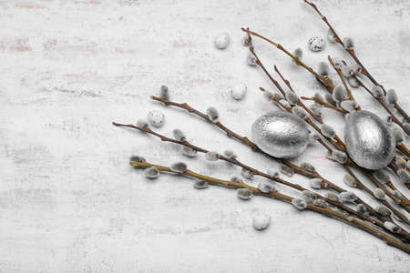 Easter eggs and pussy willow branches on light backgroundの写真素材