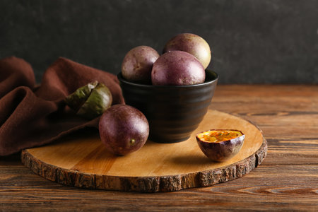Board with delicious passion fruits on wooden backgroundの写真素材