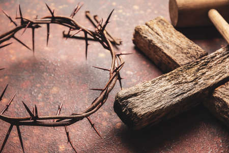 Crown of thorns with wooden cross on color backgroundの写真素材