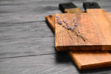 Cutting boards and lavender flowers on gray wooden background, closeupの写真素材