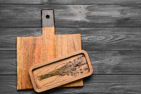 cutting board and lavender flowers on gray wooden background