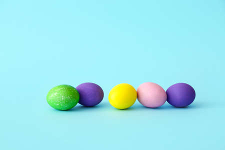 Painted eggs for easter celebration on color backgroundの写真素材