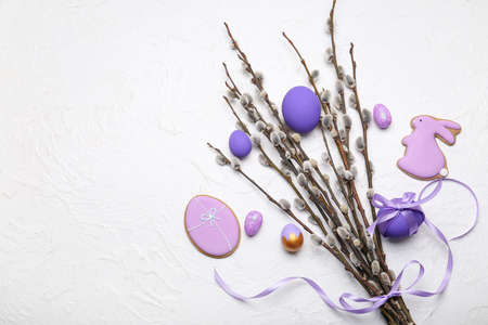 Willow branches, Easter cookies and painted eggs on light backgroundの写真素材