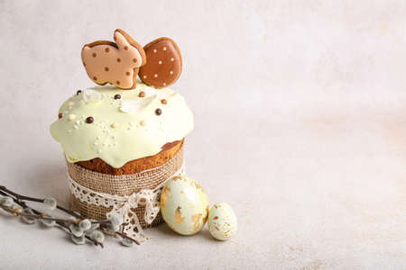 Willow branches, Easter cake and painted eggs on light background