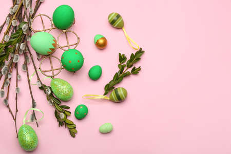 Willow branches and painted Easter eggs on pink backgroundの写真素材