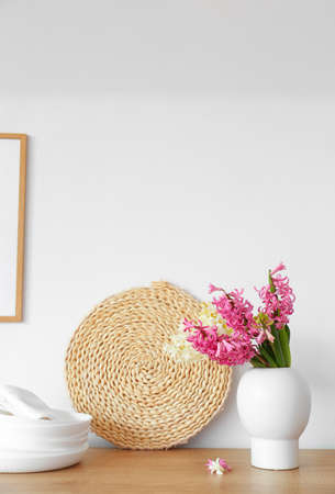 Kitchen counter with hyacinth flowers and dishware near white wallの写真素材