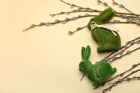 Willow branches and Easter bunnies on yellow backgroundの写真素材