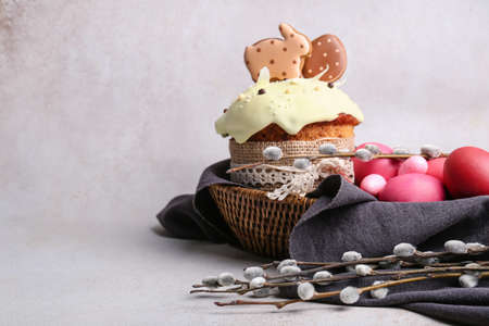 Willow branches, Easter cake and painted eggs on light background