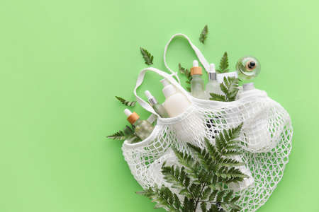 Shopping bag with natural cosmetics on color backgroundの写真素材