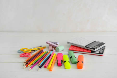 Different stationery on table near light wallの写真素材