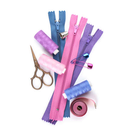 Set of colorful zippers and sewing supplies on white backgroundの写真素材