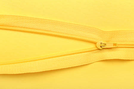 Stylish zipper on yellow background