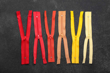 Stylish different zippers on dark backgroundの写真素材