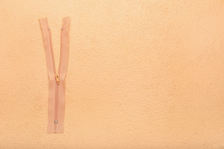 Stylish zipper on beige backgroundの写真素材