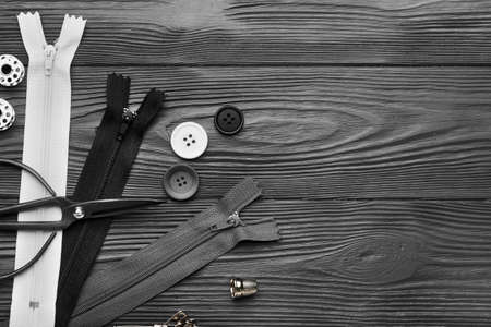Set of zippers and sewing supplies on dark wooden backgroundの写真素材
