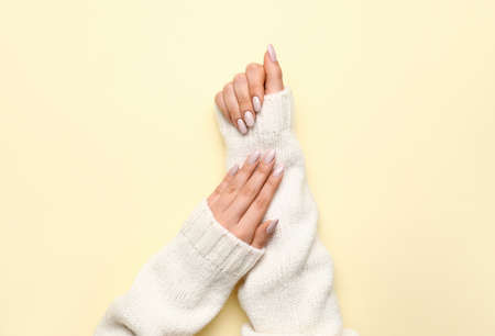 Woman with stylish manicure on yellow background, closeupの写真素材