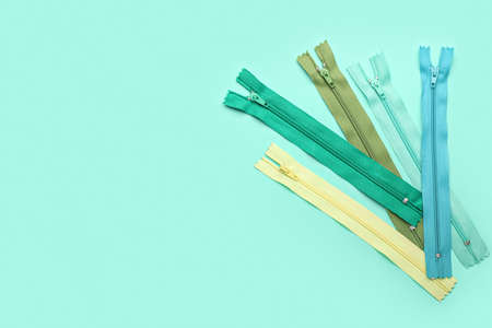 Stylish different zipper on green background