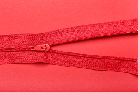 Stylish zippers on red backgroundの写真素材