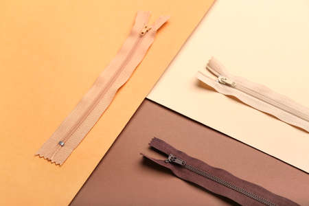 Stylish different zipper on brown backgroundの写真素材