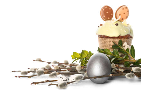 Painted Easter egg, cake and pussy willow branches on white backgroundの写真素材