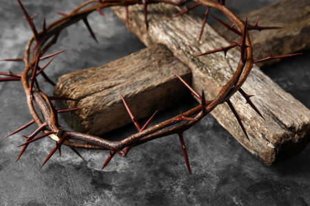 Crown of thorns with wooden cross on grunge background, closeupの写真素材