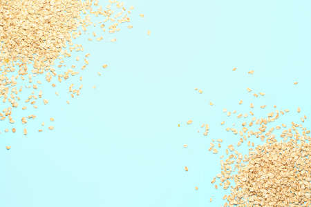 Raw oatmeal on color backgroundの写真素材