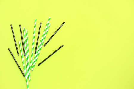 Stylish straws for drinks on green backgroundの写真素材