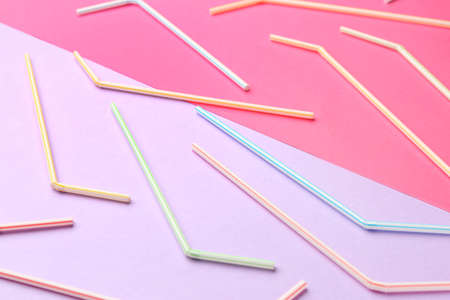 Stylish straws for drinks on pink background