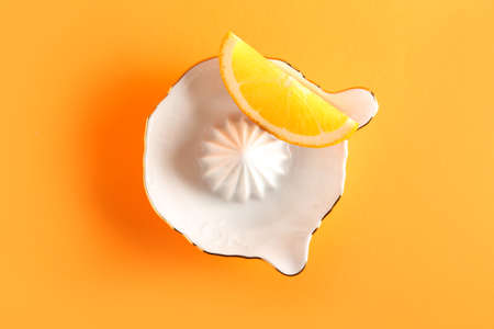 Ceramic juicer and orange on orange backgroundの写真素材