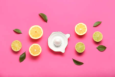 Ceramic juicer, cut lemons and limes on pink backgroundの写真素材